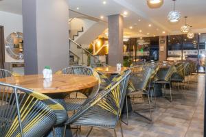 a row of tables and chairs in a restaurant at Hotel AirPort Pereira in Pereira