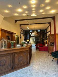a lobby with a reception desk and a living room at Hotel Am Grudenberg in Halberstadt