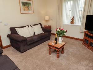 a living room with a couch and a coffee table at The Retreat in Alnwick