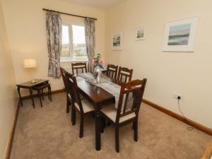 a dining room with a table and chairs and a window at The Retreat in Alnwick