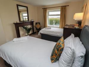 a hotel room with two beds and a mirror at The Retreat in Alnwick +31 photos