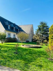 a large white house with a large yard at Angel du Mont in Pontorson