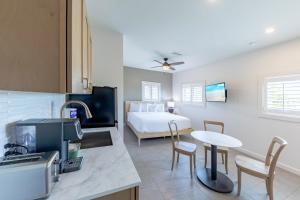a kitchen with a room with a bed and a table at The Palmetto Inn in Boca Grande
