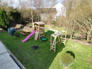 a backyard with a playground with a slide and a play set at 1 Bedroom Lodge By Travel Lets Self Catering Accommodation Rathmullen With Hot Tub in Ramelton