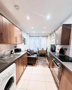 a kitchen with a sink and a dishwasher at Old Town Castle Apartment in Edinburgh