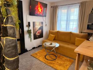 a living room with a couch and a table at Apartmán Mair Pardubice in Pardubice
