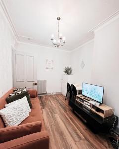 a living room with a couch and a piano at Old Town Castle Apartment in Edinburgh