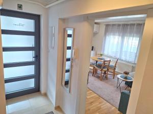 a room with a door and a dining room with a table at Apartment Silvia Zagreb- Free Private Parking, in Zagreb