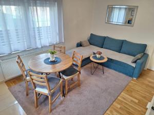 a living room with a couch and a table and chairs at Apartment Silvia Zagreb- Free Private Parking, in Zagreb