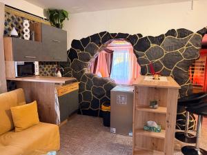 a kitchen with a living room with a couch and a kitchen at Apartmán Mair Pardubice in Pardubice