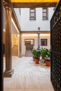 an entrance to a building with a gate and plants at Patio Nazarí Suites in Granada