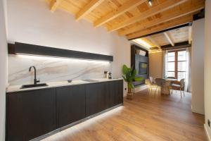 a kitchen with a sink and a counter top at Patio Nazarí Suites in Granada +42 photos