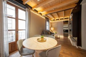 a living room with a table and chairs at Patio Nazarí Suites in Granada