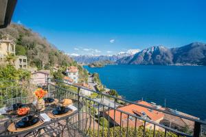 a balcony with a view of the water and mountains at Alba on Lake Como by Rent All Como in Sala Comacina