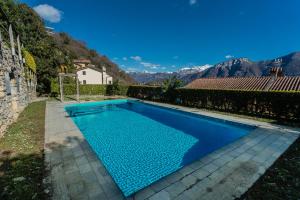 a swimming pool in the backyard of a house at Alba on Lake Como by Rent All Como in Sala Comacina
