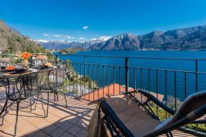 a balcony with a view of the water and mountains at Alba on Lake Como by Rent All Como in Sala Comacina