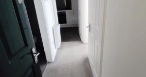 a hallway with an open door and a room with a kitchen at New Town Residence in Edinburgh