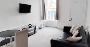 a living room with a couch and a table at New Town Residence in Edinburgh