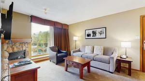 a living room with a couch and a chair at Cascade Lodge in Whistler