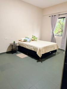 a bedroom with a bed and a window at GuestHouse Encanto del Centro 2 in Encarnación +2 photos