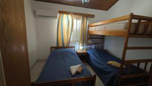 a bedroom with two bunk beds and a ladder at Manors Seaside 2BR House 100m from the Beach & Free Parking in Meneou