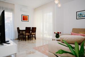 a living room with a couch and a table at Bellavista Garden in Baošići