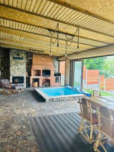 a patio with a pool table and a fireplace at Cabana Grama -ponton privat și jacuzzi pe Lacul Cinciș in Cinciş