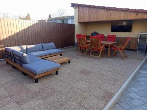 a patio with a couch and chairs and a table at President Apartmanház - Nincs szomszéd - Egy időben,egy társaság - in Békéscsaba