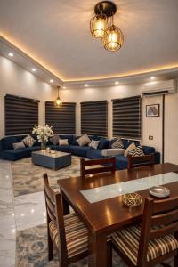 a living room with a table and a blue couch at Luxury Villa Z7 - 6th of October in 6th Of October