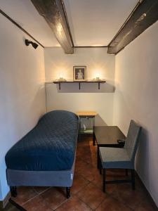 a room with a bed and a table and a chair at Ojcówek in Grzymek