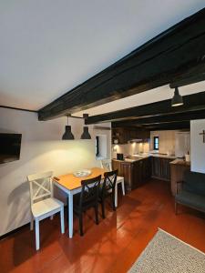 a kitchen and dining room with a table and chairs at Ojcówek in Grzymek
