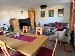 a living room with a table and a couch at Ferienhaus Big Family in Ellrich
