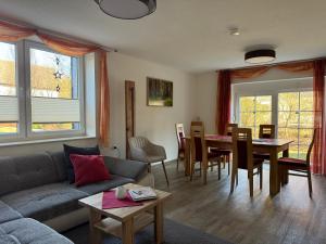 a living room with a couch and a table at Ferienhaus Big Family in Ellrich