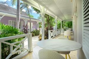 a white porch with a white table and chairs at Trupial Hotel & Casino in Willemstad