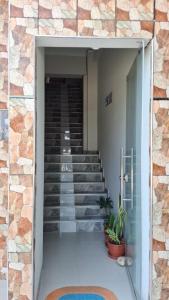 a staircase in a building with a glass door at Hospedaje Jasmine in Tarapoto
