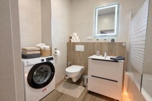 a bathroom with a washing machine and a washer at Station APA s parkovaním in Michalovce
