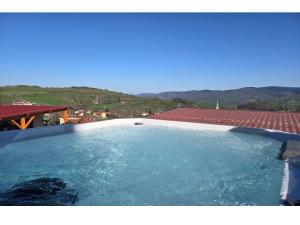 a large pool of water with mountains in the background at Tiny d'Monts in Brullioles