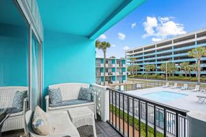 a balcony with a view of a pool and a building at Pool Front & Across from Beach in Myrtle Beach
