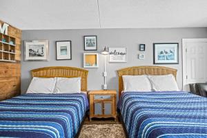 two beds sitting next to each other in a bedroom at Pool Front & Across from Beach in Myrtle Beach +24 photos