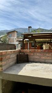 a brick building with a gate in front of a house at La Casita de Lorena in El Bolsón +11 photos