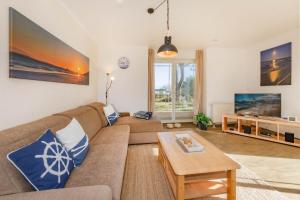 a living room with a couch and a table at Haus Strandoase 04 in Bansin