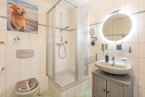 a bathroom with a shower and a sink and a toilet at Haus Strandoase 04 in Bansin +5 photos