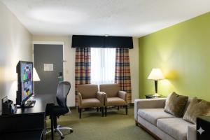 a living room with a couch and chairs in a room at Quality Inn & Suites Moline Airport in Moline