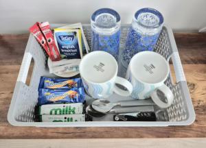 a white basket filled with food and drinks at Sea Breeze - Sea Scape View in Keiss