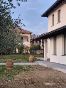 a house with two large vases sitting outside of it at FRANCIACORTA LAKELAND Lodge in Capriolo