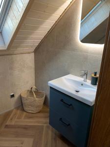 a bathroom with a sink and a skylight at Białe Żagle Mazury in Węgorzewo +64 photos