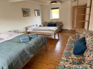 a living room with two beds and a couch at Ferienhaus Big Family in Ellrich
