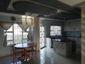a kitchen with a table and a table and chairs at 1 at Gurnard in Newlands