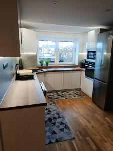 a kitchen with a refrigerator and a counter top at Apartmán Forst in Nová Lesná
