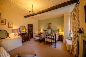 a bedroom with two beds and a mirror at Cantre Selyf in Brecon